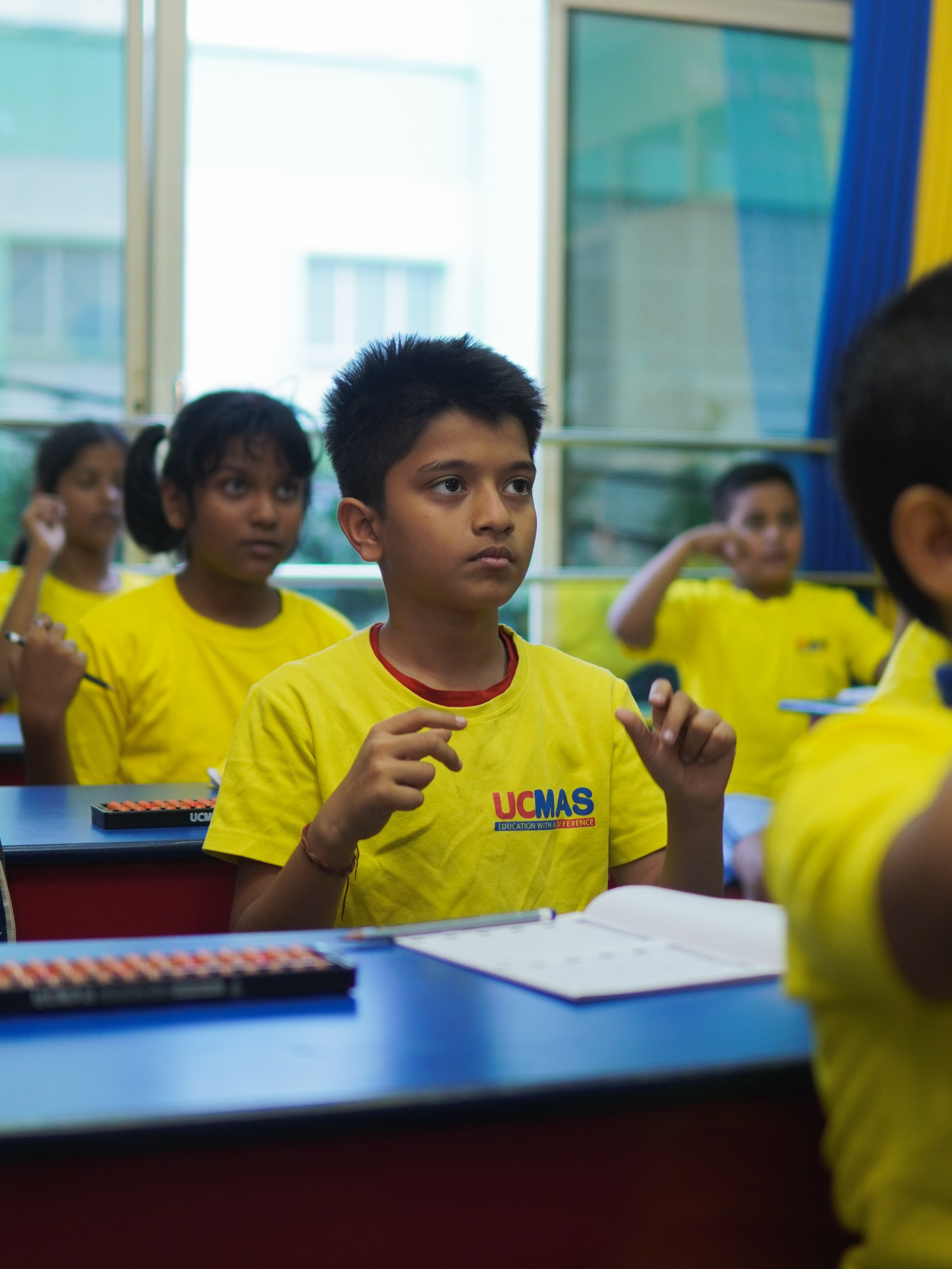 UCMAS children learning abacus mental arithmetic in a classroom